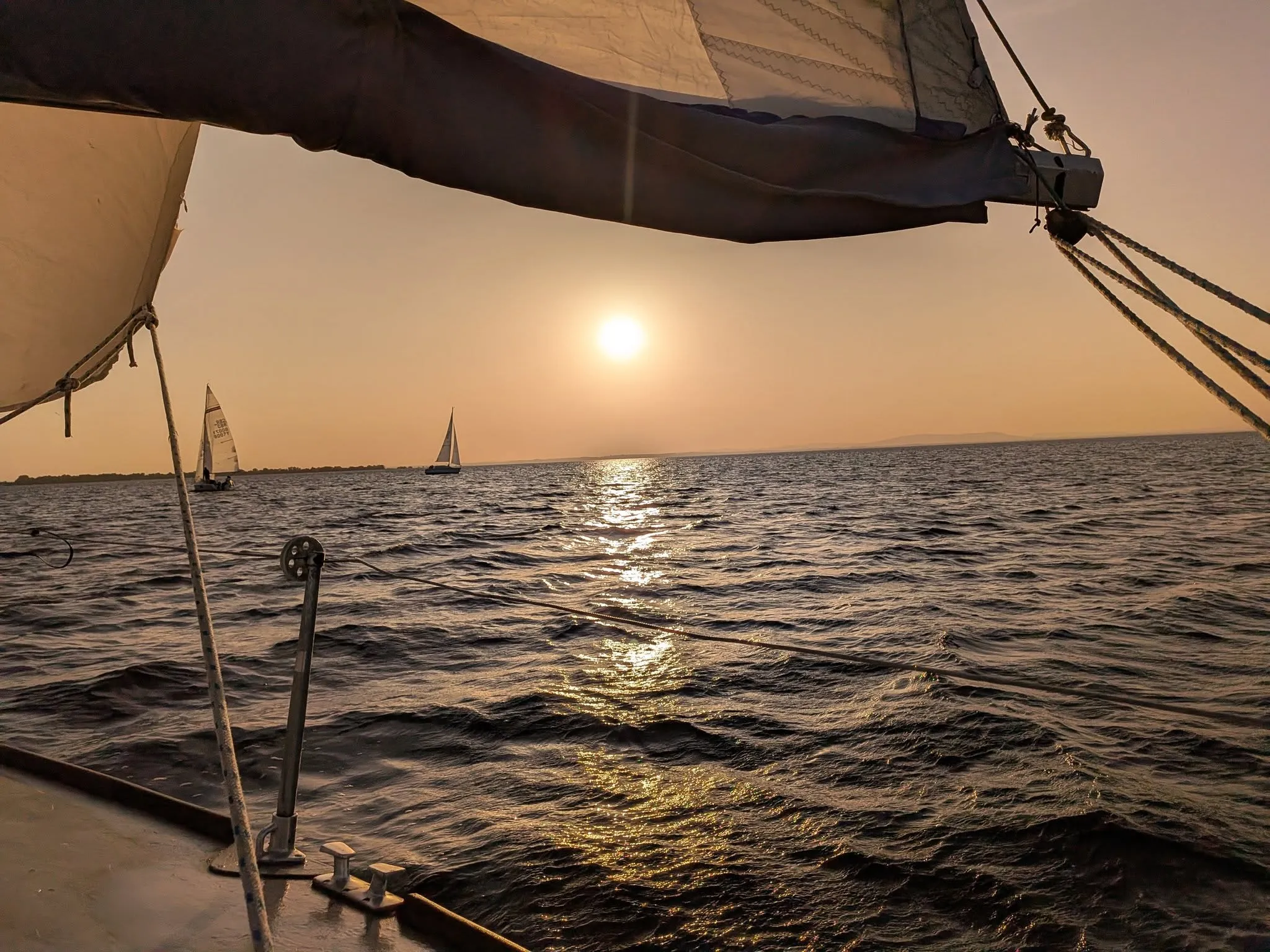 Sunset over Lough Neagh from the deck of a keelboat