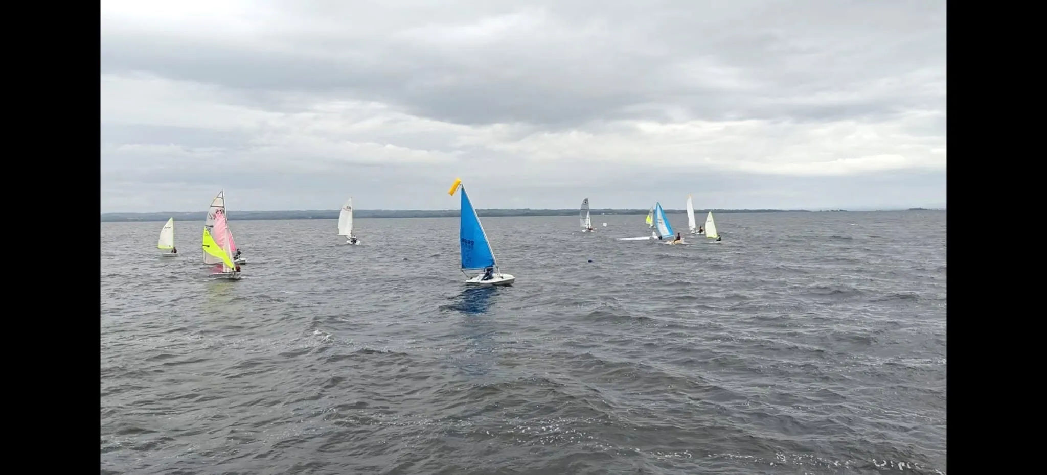 Dinghies flying colourful spinnakers across the lough